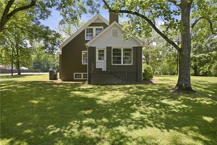 This charming home offers a lush, expansive yard perfect for outdoor enjoyment and relaxation.