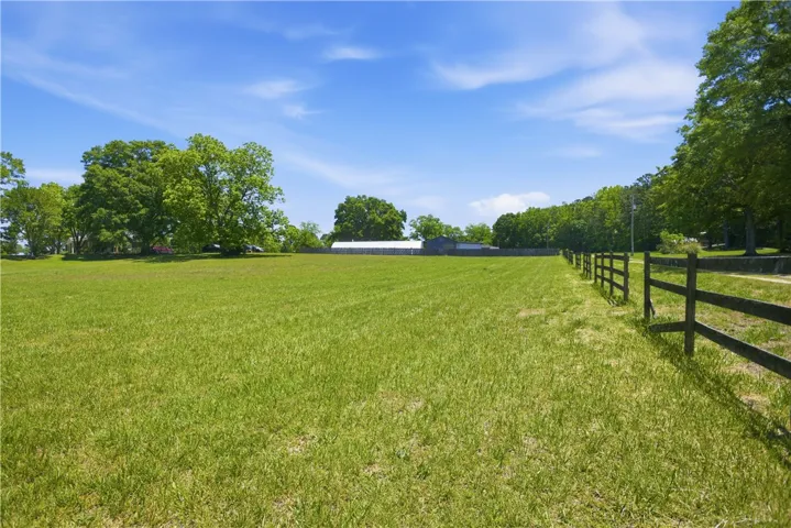 Expansive green acreage featuring a sturdy fence line, ideal for pastoral pursuits.