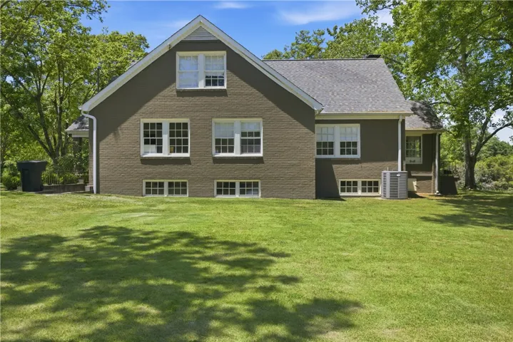 This charming home features a well-maintained exterior and a lush green lawn, offering a serene outdoor space.