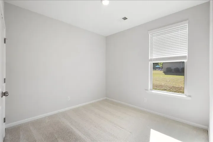 This bright and airy room offers a tranquil retreat with a refreshing outdoor view.