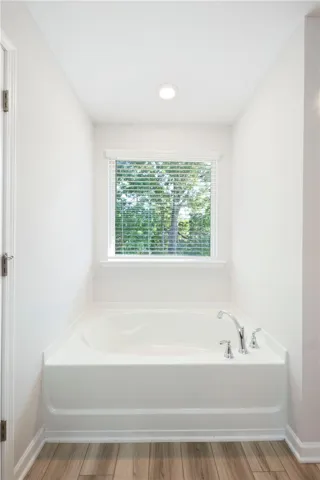 This serene bathroom offers a soaking tub, perfect for unwinding after a long day.