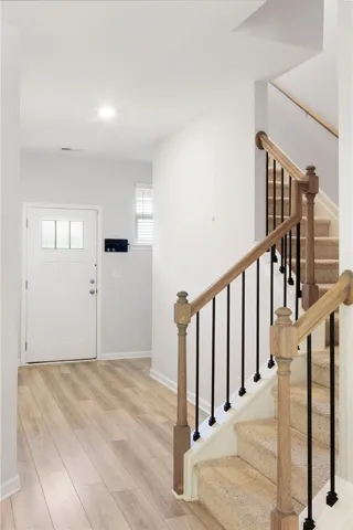 This bright entryway features a staircase leading to additional levels.