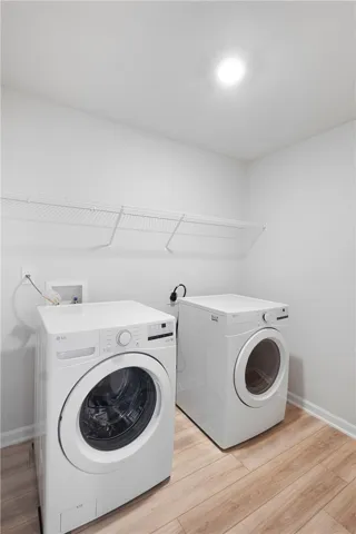 This laundry area features convenient appliances and practical storage solutions.