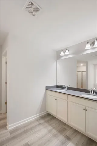 This sleek bathroom features a spacious double vanity, perfect for daily routines.