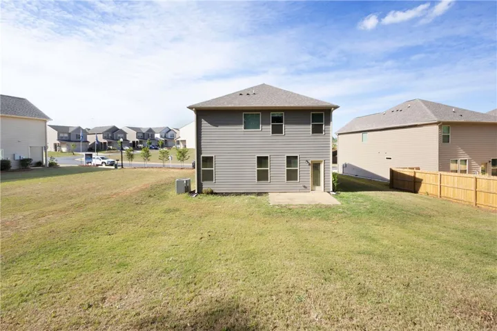 This spacious backyard with a concrete patio offers ample room for outdoor activities and future enhancements.