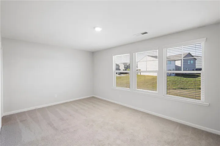 This bright, spacious room offers abundant natural light and versatile living space.