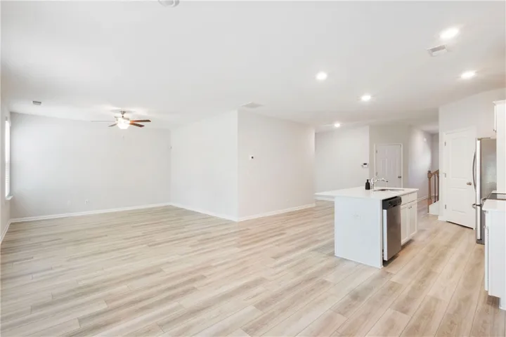 This bright, open concept living space seamlessly integrates with the modern kitchen, ideal for entertaining.