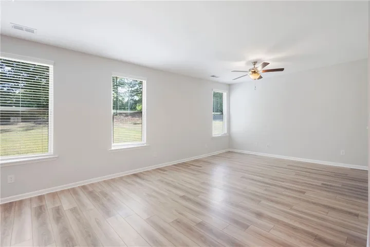 This airy room features durable flooring and ample natural light, ideal for peaceful living.