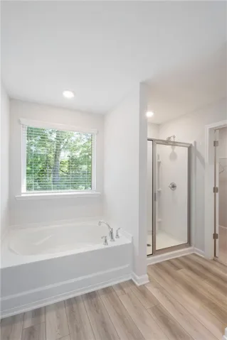 This bathroom offers a refreshing shower and a tranquil tub, creating a spa-like retreat.