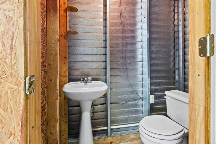 This functional bathroom provides essential amenities within a compact, utilitarian space.