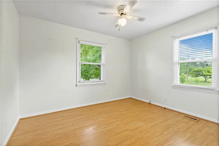 This bright room features beautiful flooring and abundant natural light.
