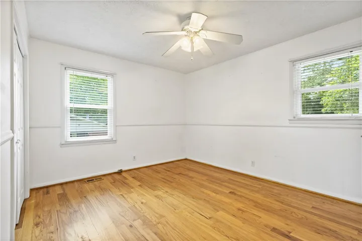 This airy room features durable hardwood flooring and abundant natural light.