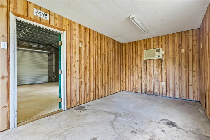 This versatile garage space offers ample room for vehicles or a workshop, featuring a convenient roll-up door.