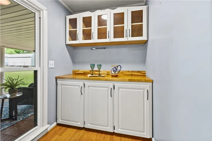 This inviting nook features stylish cabinetry and gleaming countertops, perfect for entertaining.