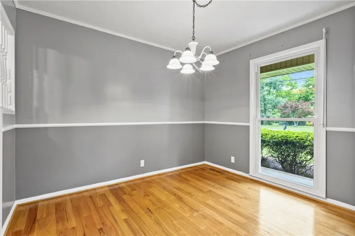 This bright space features gleaming hardwood floors and ample natural light from a large window.