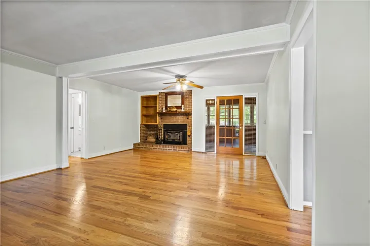 This inviting living area features hardwood floors, a cozy fireplace, and abundant natural light.