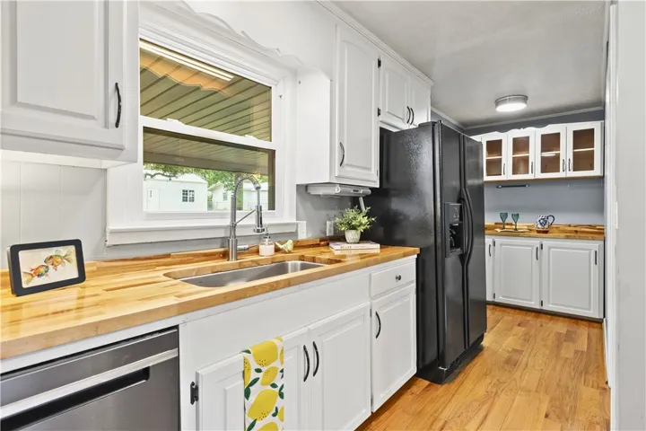 Bright and inviting kitchen featuring warm wood countertops and modern appliances.