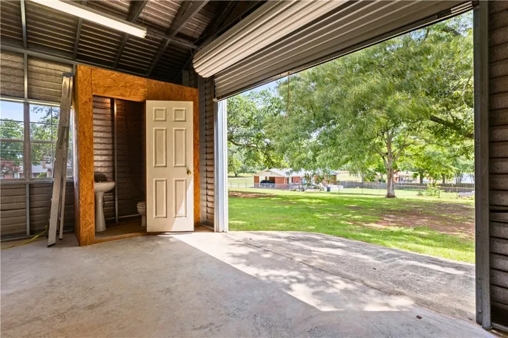 This versatile garage offers ample space and convenient access to a private yard with mature trees.
