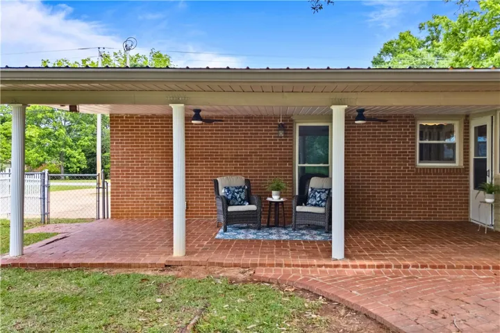 This inviting covered patio offers a perfect space for outdoor relaxation and entertaining.