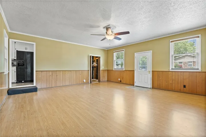 This bright living space features wood paneling and easy-care flooring, ready for your personal touch.