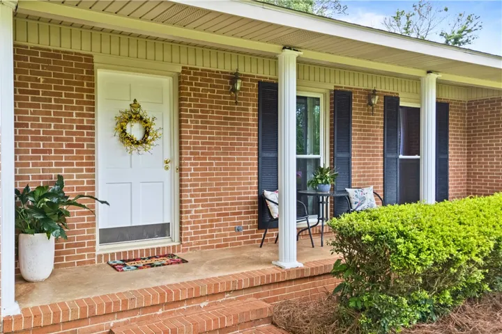 This charming brick home offers a welcoming facade with classic architectural elements.