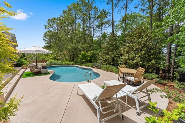 Enjoy outdoor living with this inviting pool area, perfect for relaxation and entertaining.