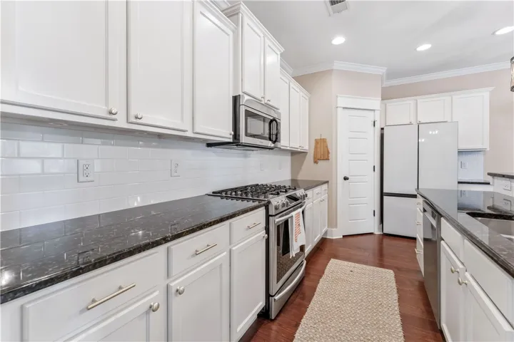 This bright kitchen features sleek appliances and ample counter space, perfect for culinary endeavors.