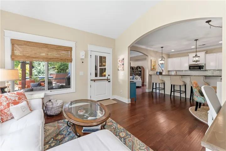 This inviting space features an open layout connecting living, dining, and kitchen areas.
