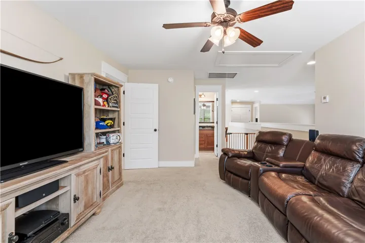 An inviting family room with carpeted floors provides ample space for relaxation and entertainment.