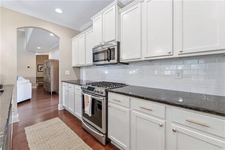 This contemporary kitchen features bright cabinetry, modern appliances, and a seamless flow into the living area.