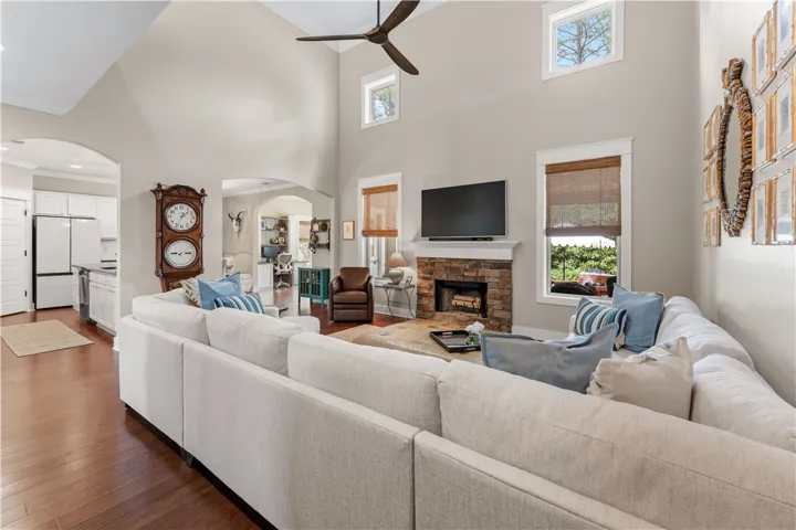 This airy living area features high ceilings and a cozy fireplace, perfect for relaxation.