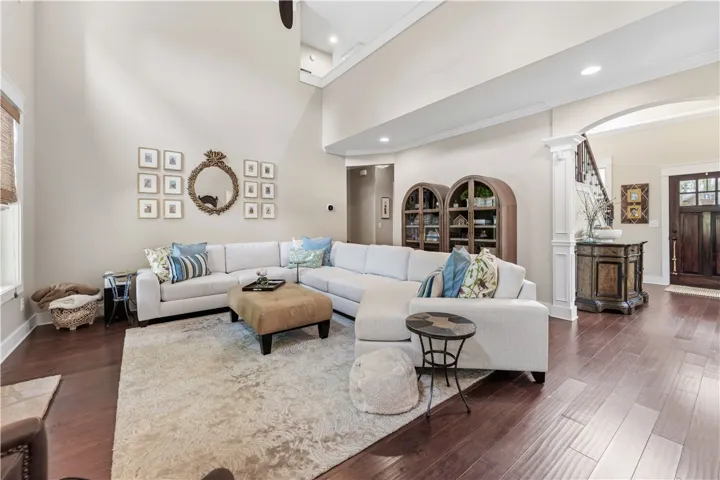 This living room features gleaming hardwood floors and high ceilings, creating an airy and elegant atmosphere.