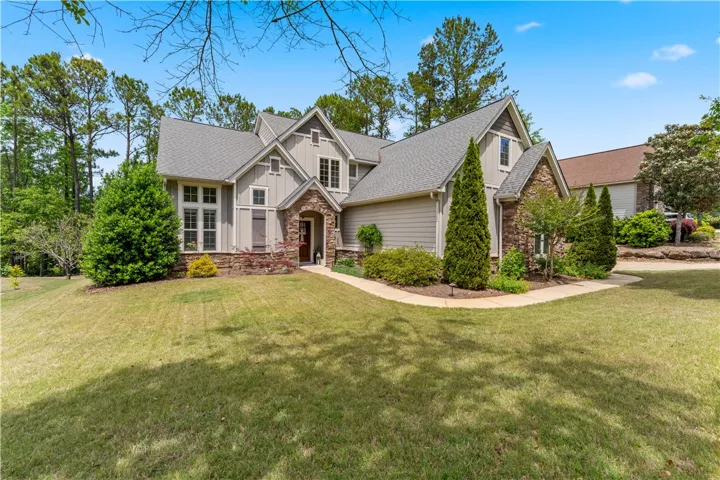 This charming residence features a well-maintained lawn and an inviting entrance.