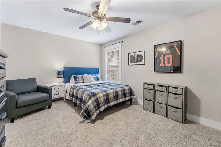 This inviting bedroom provides a comfortable retreat, featuring thoughtful design elements and ample space.