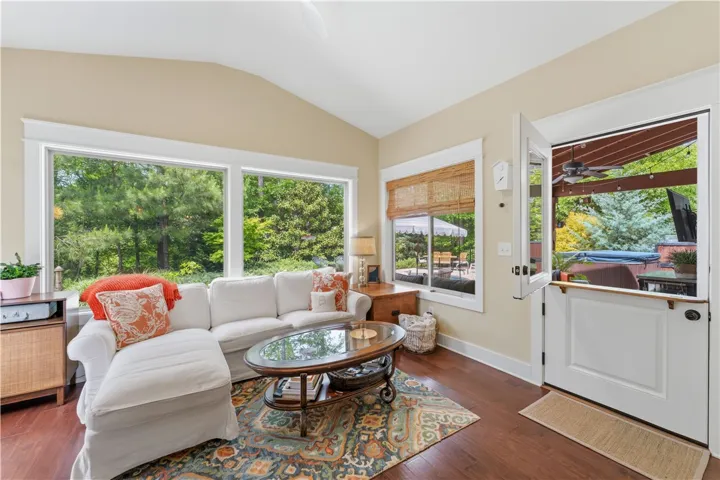 This bright living area features expansive windows and direct outdoor access.