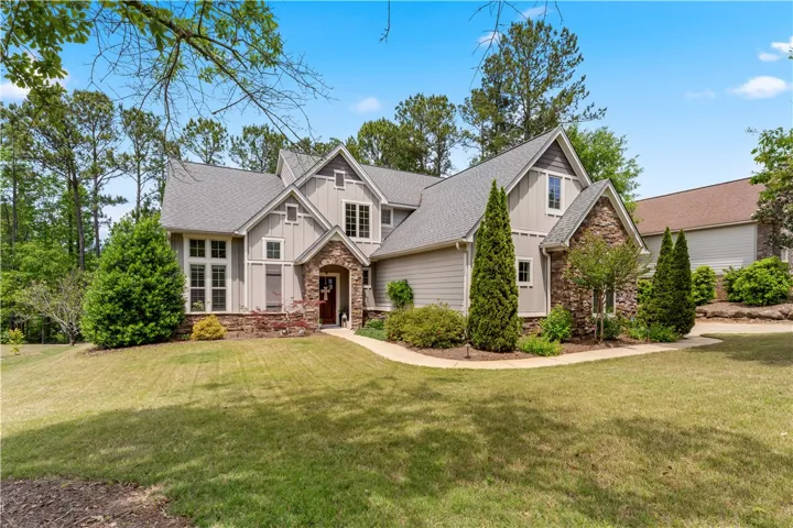 This charming home features a well-maintained lawn and an inviting entrance.