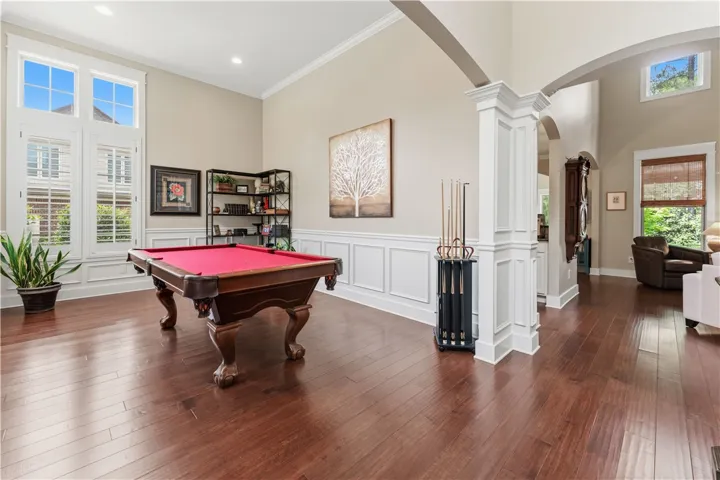 This versatile room, featuring hardwood floors, offers an ideal space for recreation and entertainment.