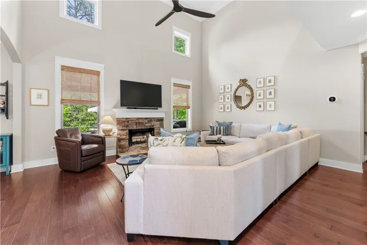 This living room features vaulted ceilings and rich hardwood flooring, creating an inviting atmosphere.
