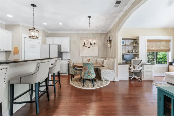 This inviting space features an open-concept kitchen, dining area, and dedicated home office nook.