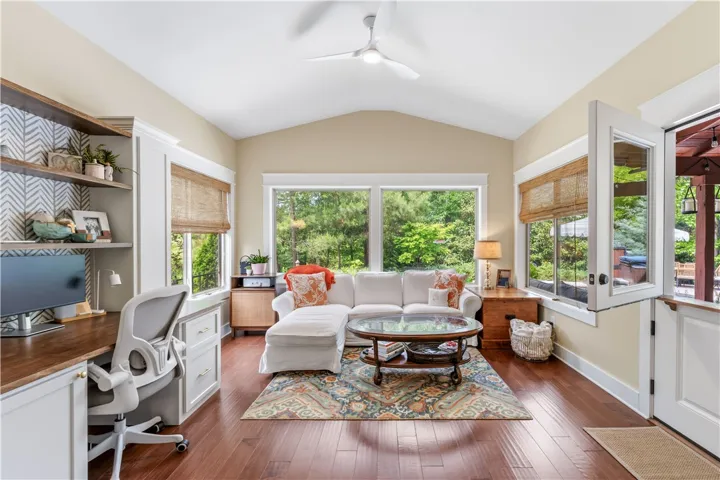 This bright and airy living space seamlessly connects to the outdoors, offering serene views.