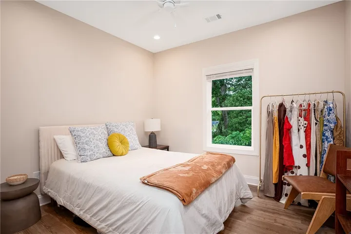 This inviting bedroom provides a serene retreat with views of lush greenery.