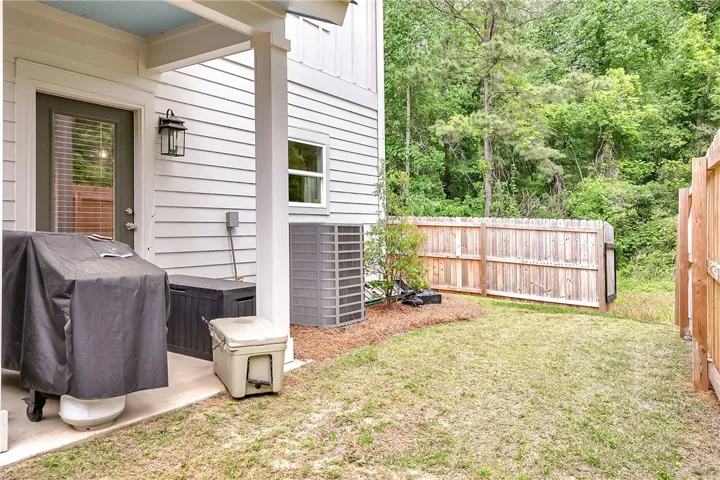 This private outdoor space features a well-maintained yard, perfect for serene moments outdoors.