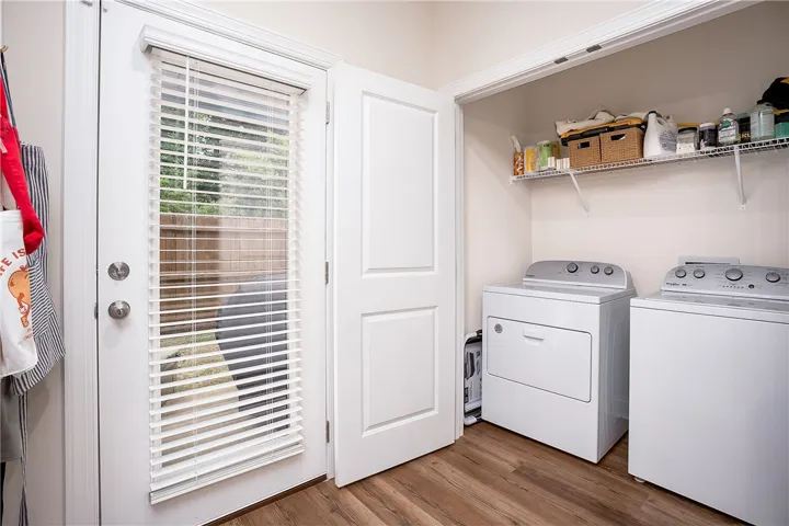This laundry area features modern appliances and convenient storage solutions.