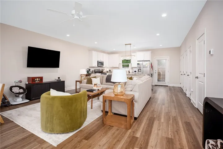 An inviting open-concept living space features warm flooring and a well-appointed kitchen.