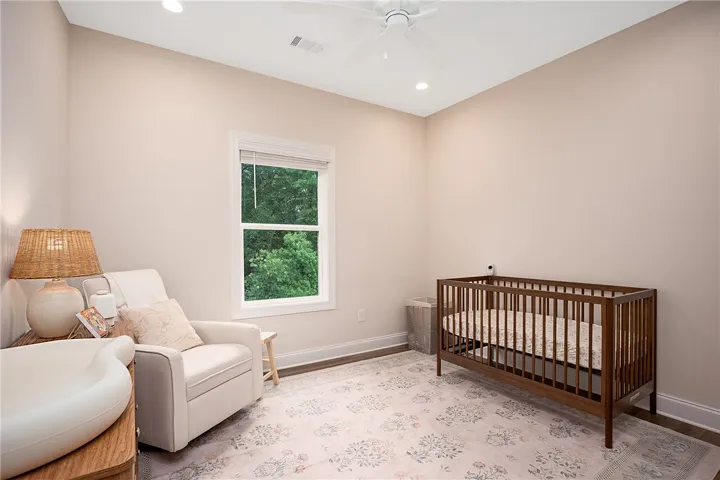 This serene bedroom offers a peaceful retreat with ample natural light.