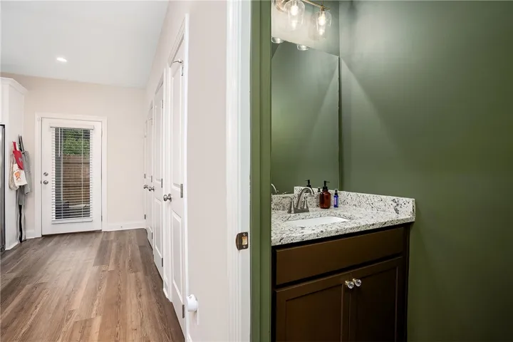 This interior hallway features sleek flooring and a well-appointed bathroom vanity.