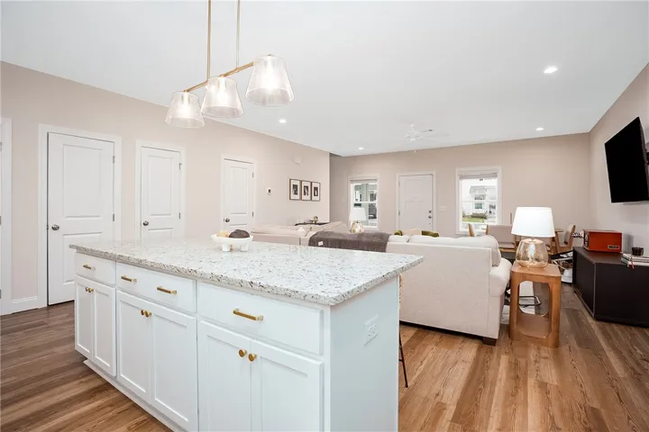 This inviting space combines a functional kitchen island with comfortable living and dining areas, ideal for gatherings.