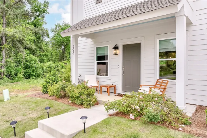This charming residence features a welcoming front porch, perfect for enjoying peaceful outdoor moments.