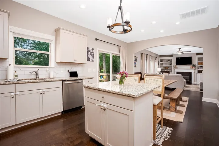 This modern kitchen features an island, ample counter space, and opens to a spacious living area.