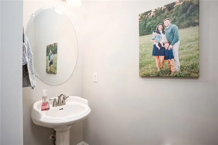 This clean and functional bathroom features a classic pedestal sink.